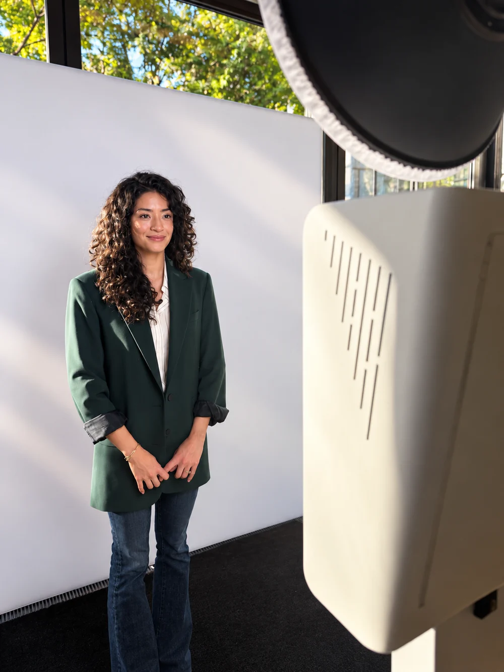 A guest in the portrait area with a white backdrop, studio light, and Snaptrend booth