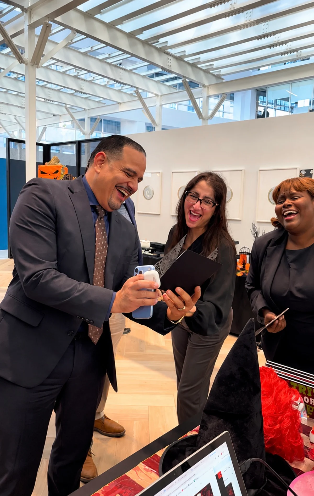 BNY guests laughing together while looking at a photo at the keepsake pickup table