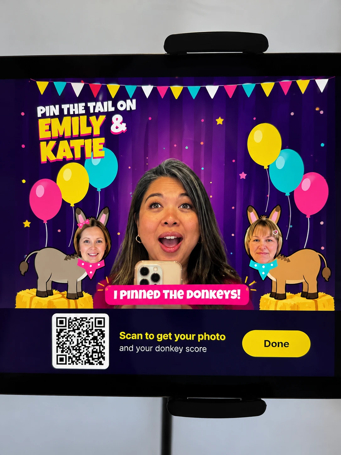 Supplied Play Booth screen example showing a guest photo, colorful game artwork and a QR code