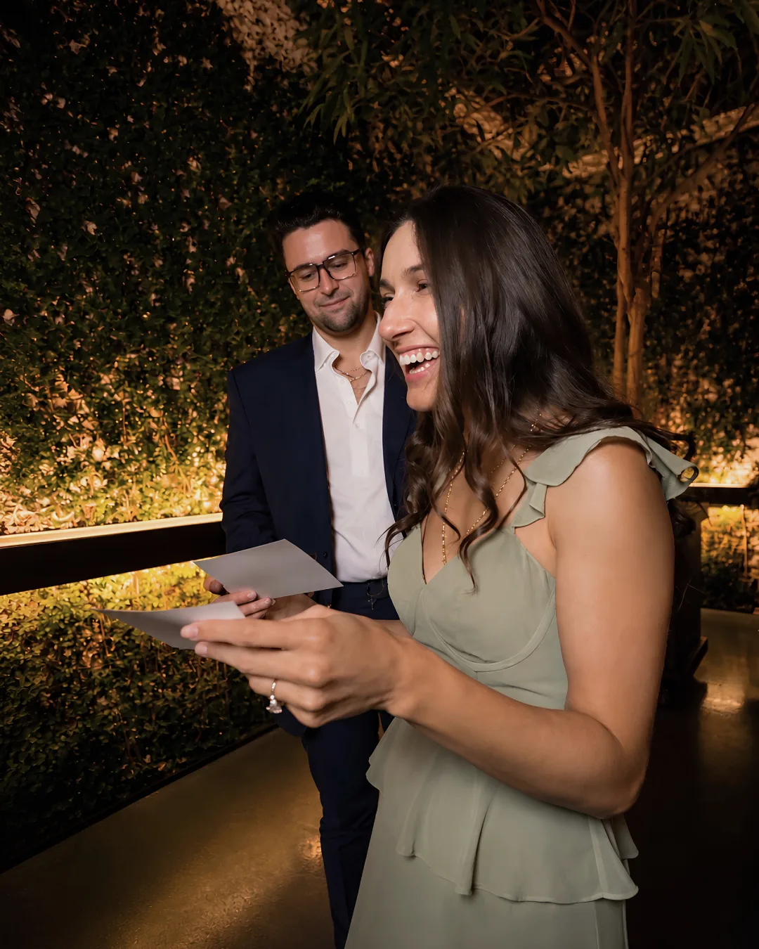 A guest smiles while looking at a photo print