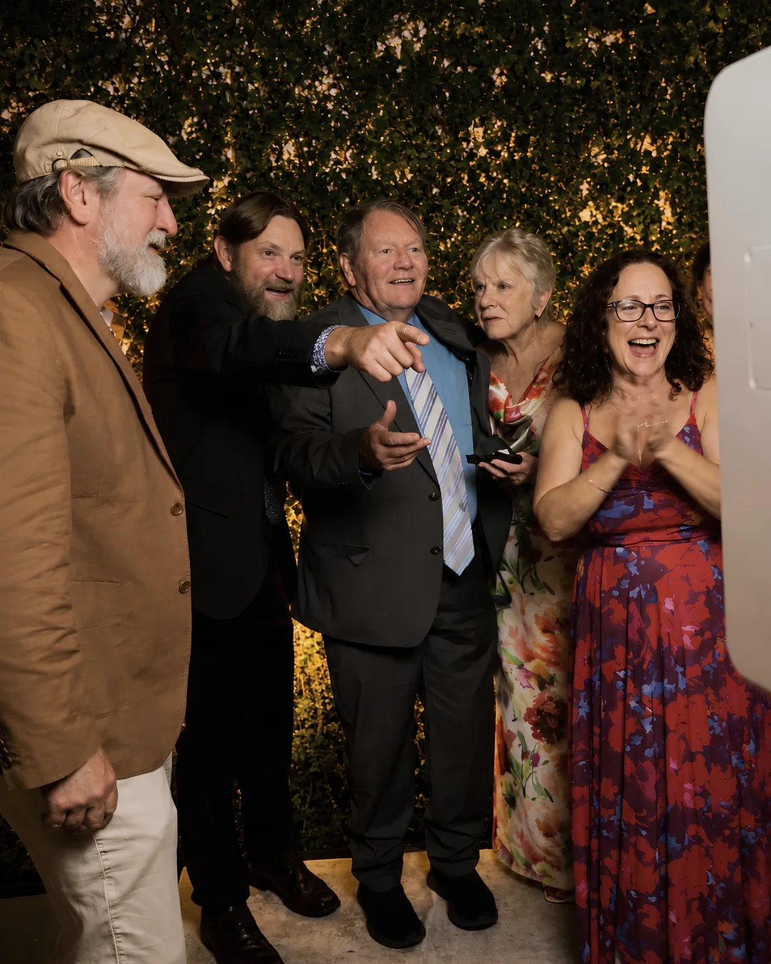 A group of guests share a joyful moment at the booth
