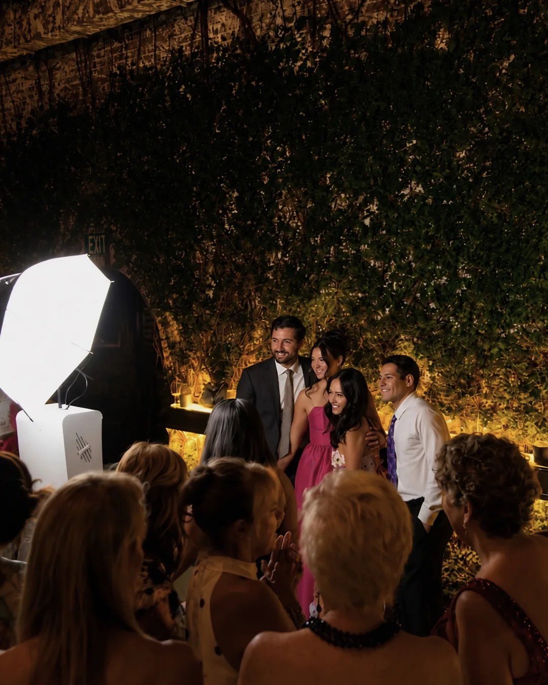 A wider view of guests gathered around the booth