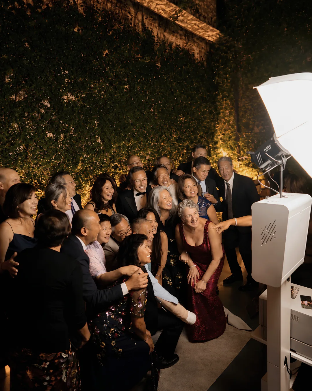 A large group gathers for a photo beside the booth lighting