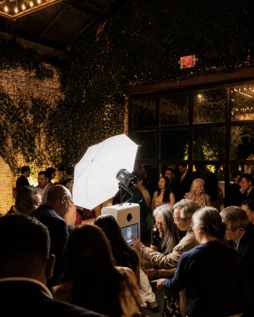 Guests gather around the photo booth during the reception