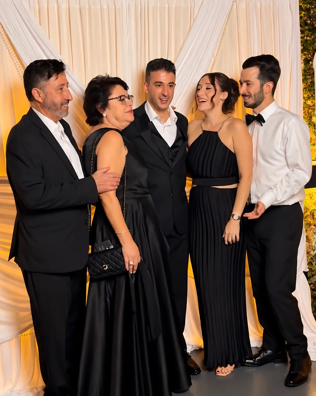 Five guests gather for a group portrait
