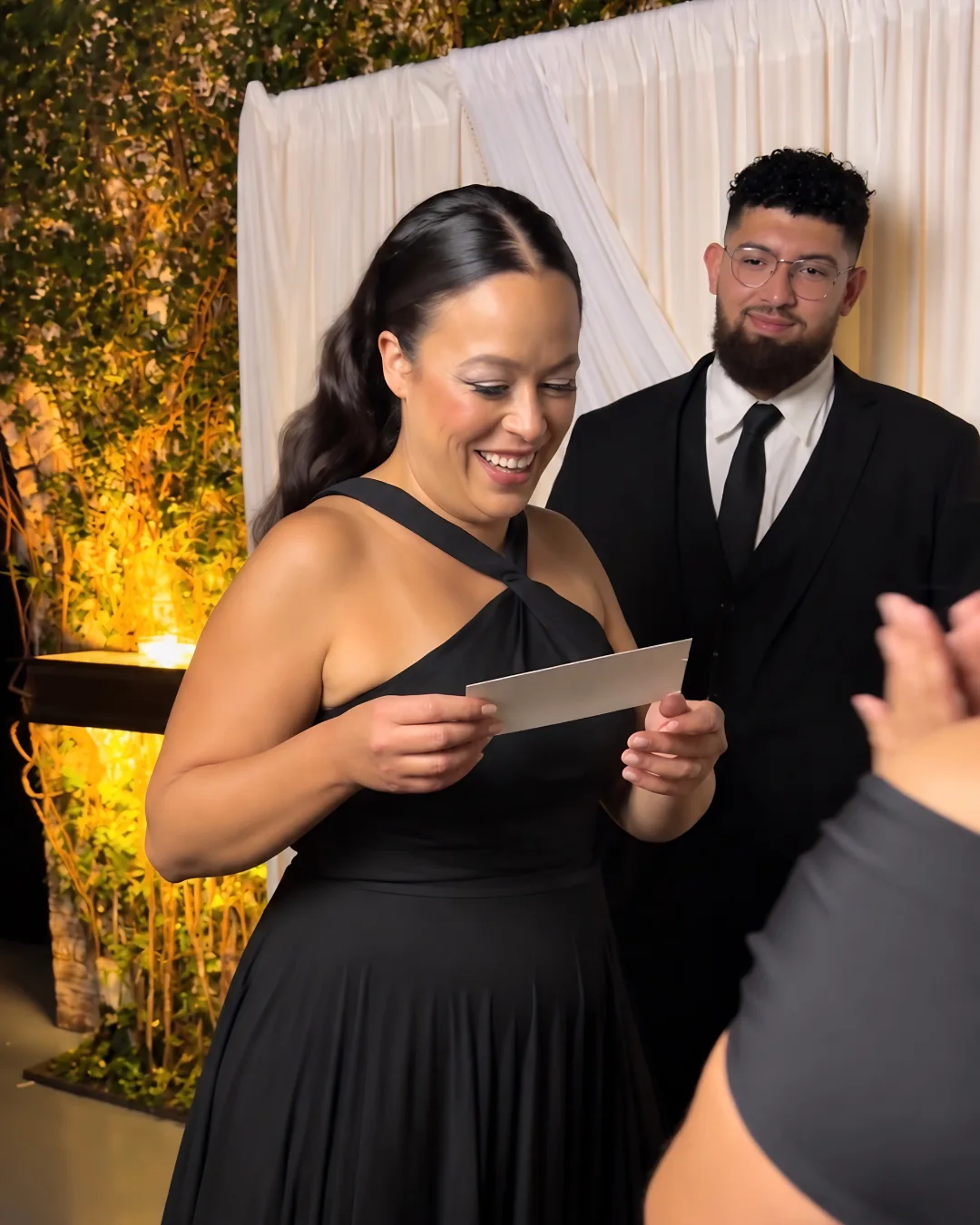 A guest smiles while holding a photo print