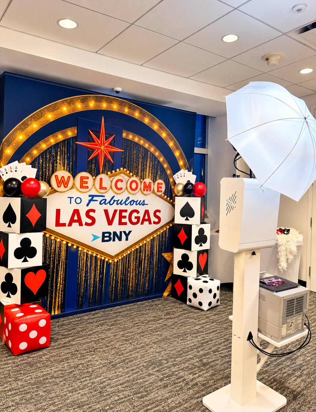 Holiday in Vegas themed booth setup with casino-inspired backdrop and props