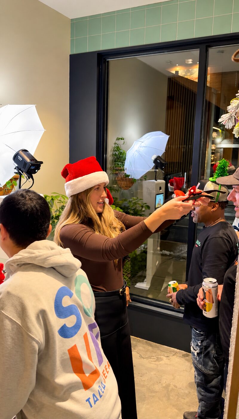 Guests choosing festive accessories beside the holiday photo booth