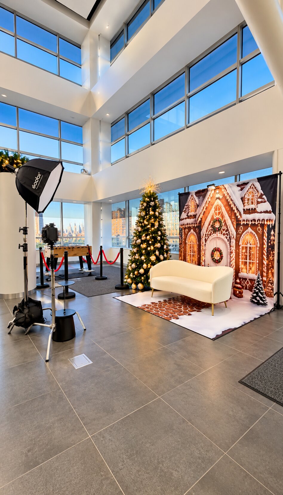Gingerbread-house photo backdrop and Christmas tree ready for a holiday celebration