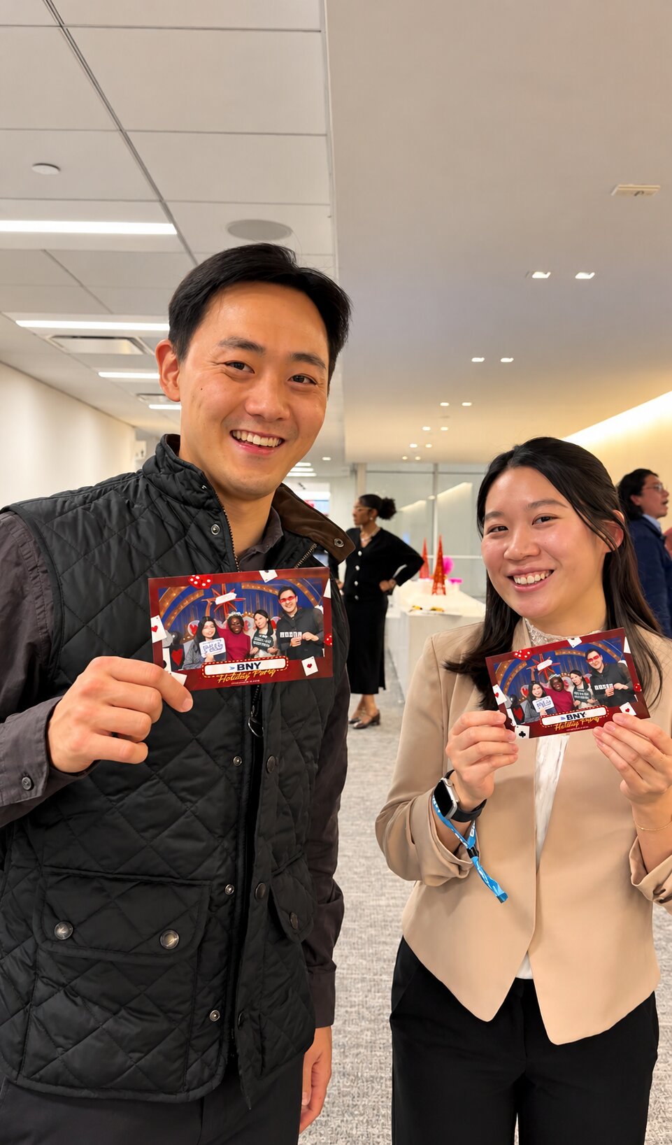 Two guests showing off their printed photo keepsakes
