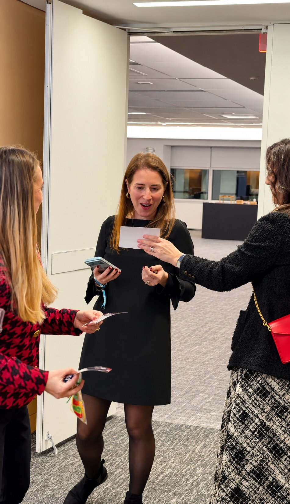 Guests reacting to a printed photo from the celebration