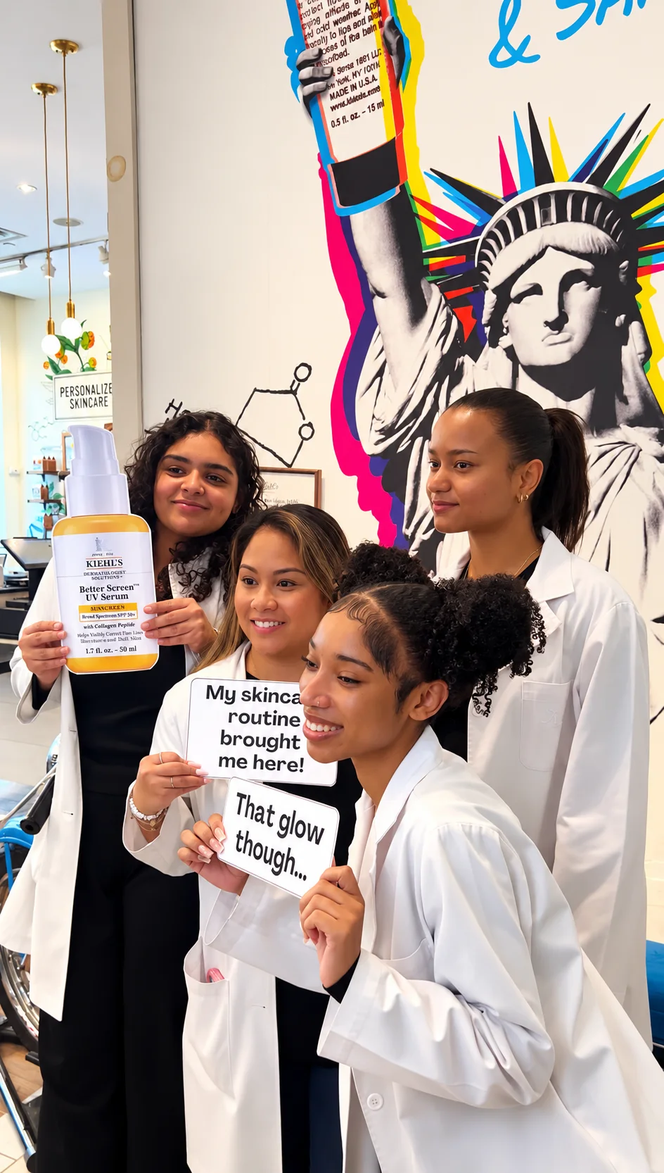 Four guests posing with Kiehl’s skincare props at a beauty activation