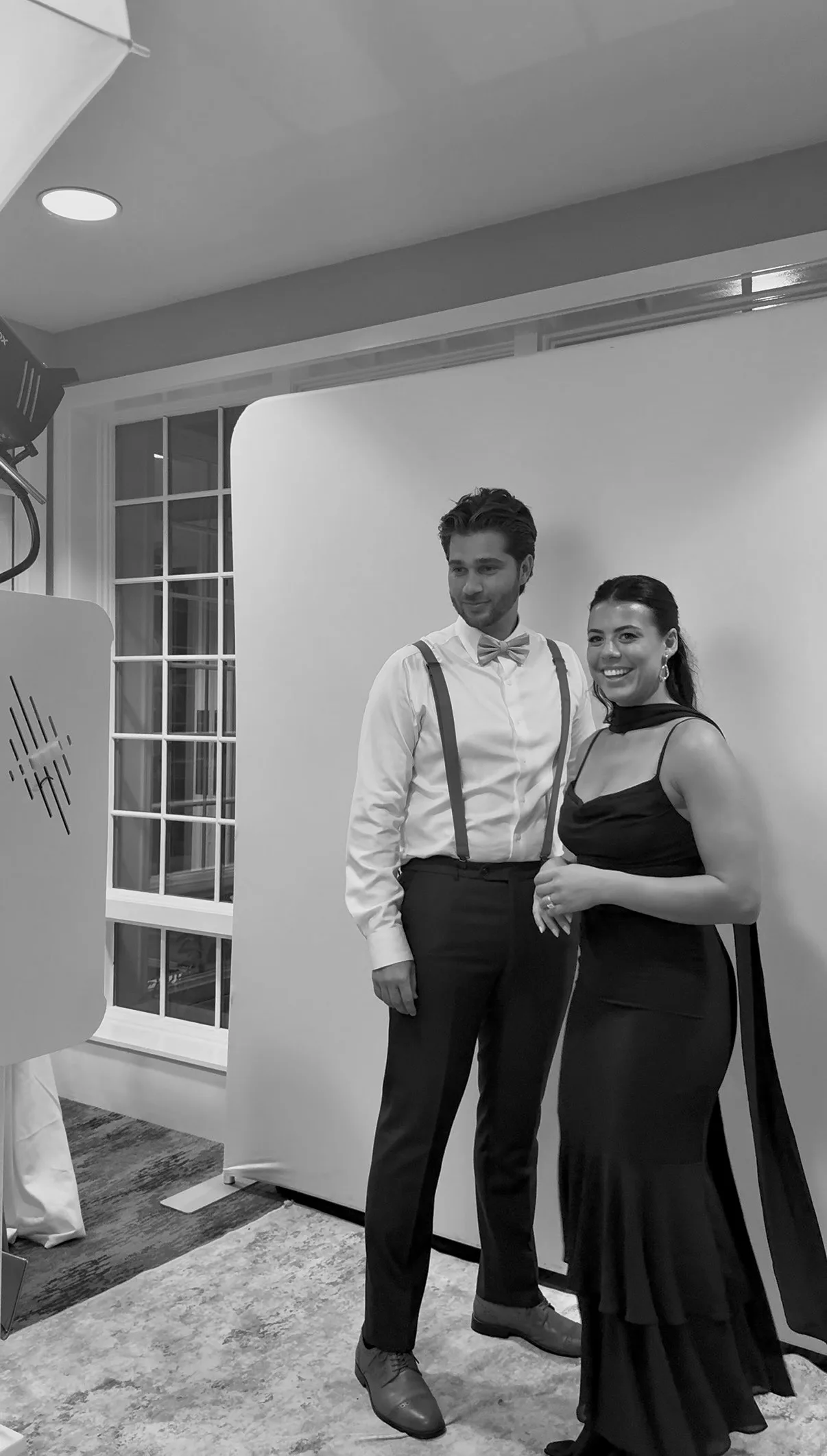 Two guests pose beside the Glam Booth