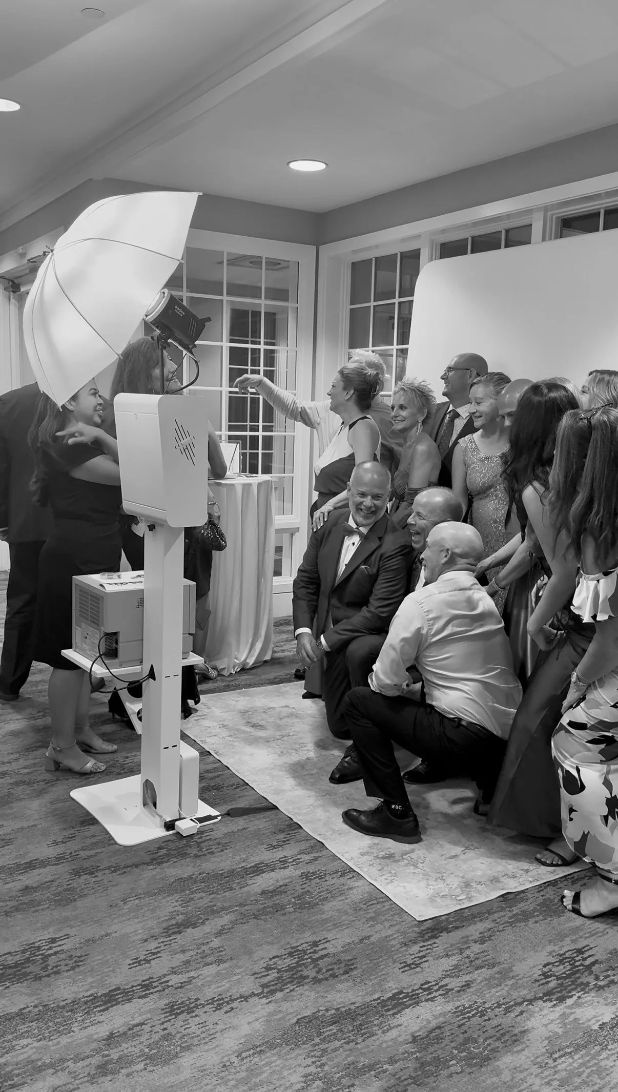 Wedding guests arrange themselves for a group photo
