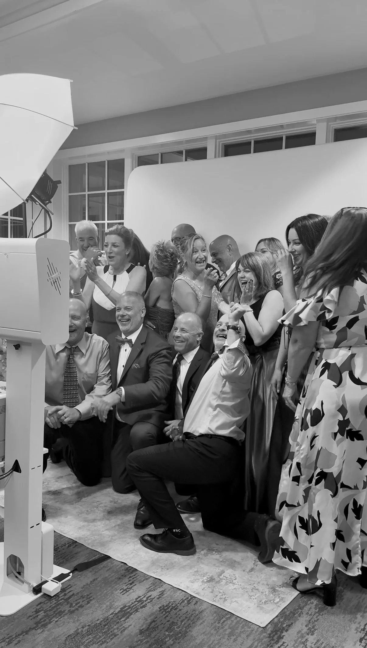 Guests gather close together for a booth portrait