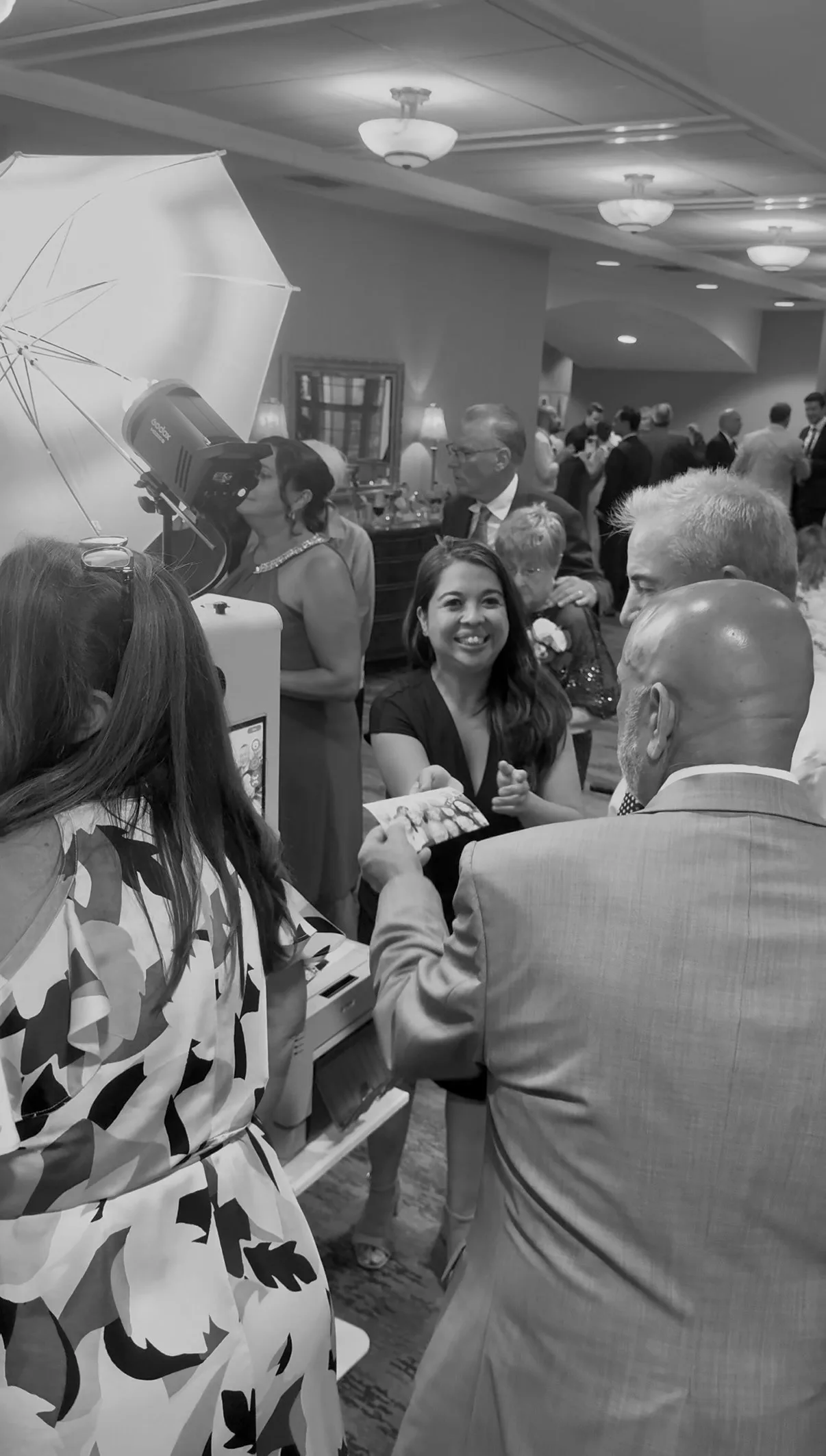 A crowded scene around the wedding photo booth