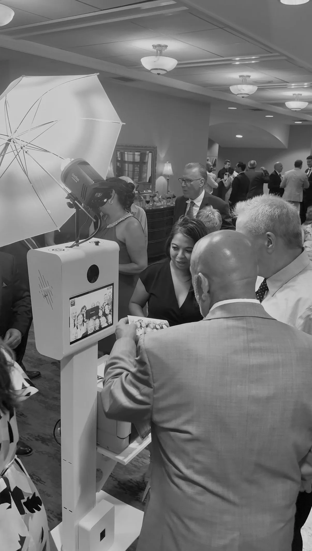 Guests look toward the Glam Booth camera and light