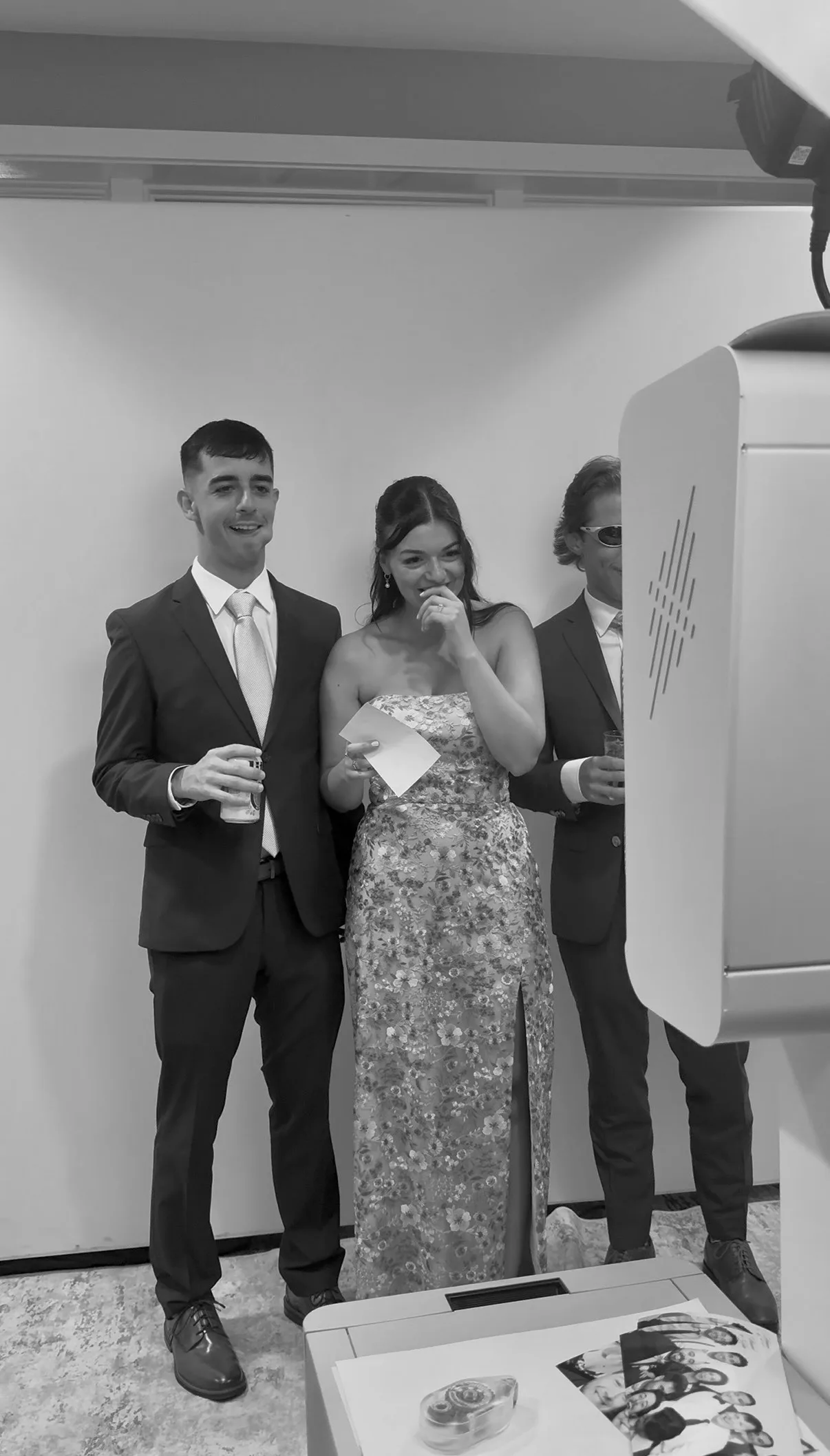 Guests pose for a portrait in front of the white backdrop