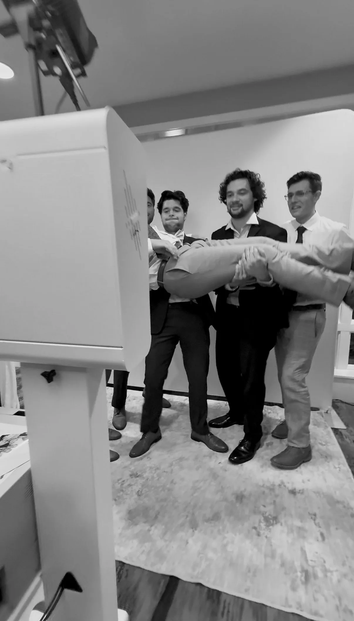 Guests pose playfully behind the Glam Booth camera
