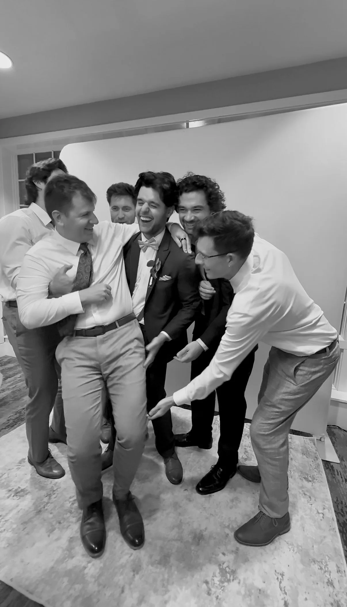 A group of guests laugh together at the photo booth