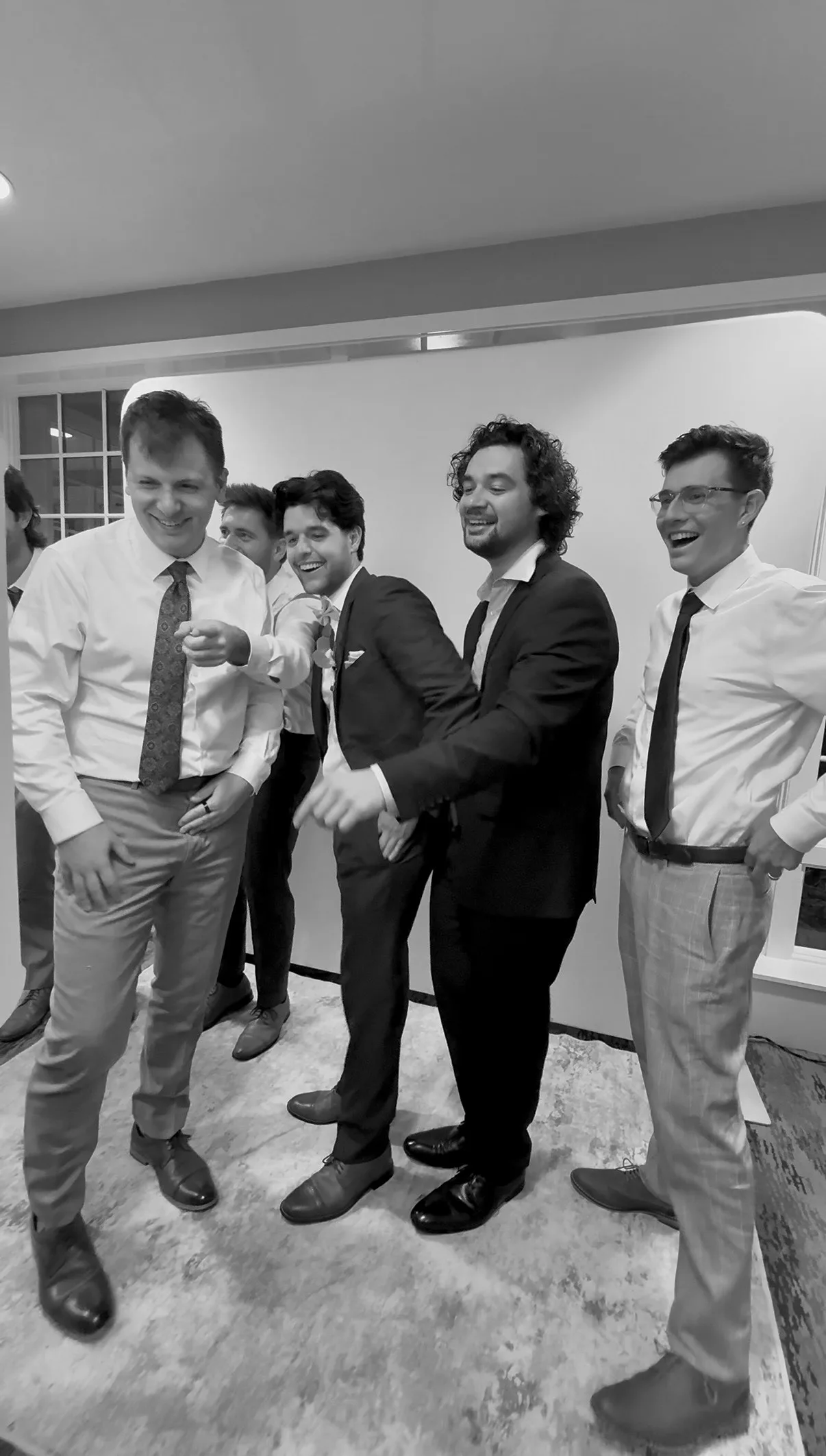 Four guests smile in front of the white backdrop