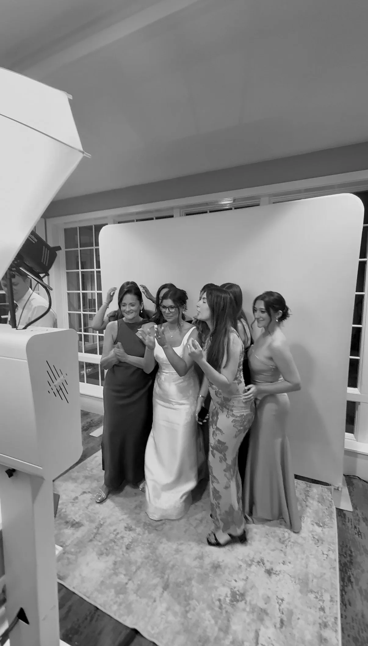 Guests arrange themselves around the bride for a booth photo