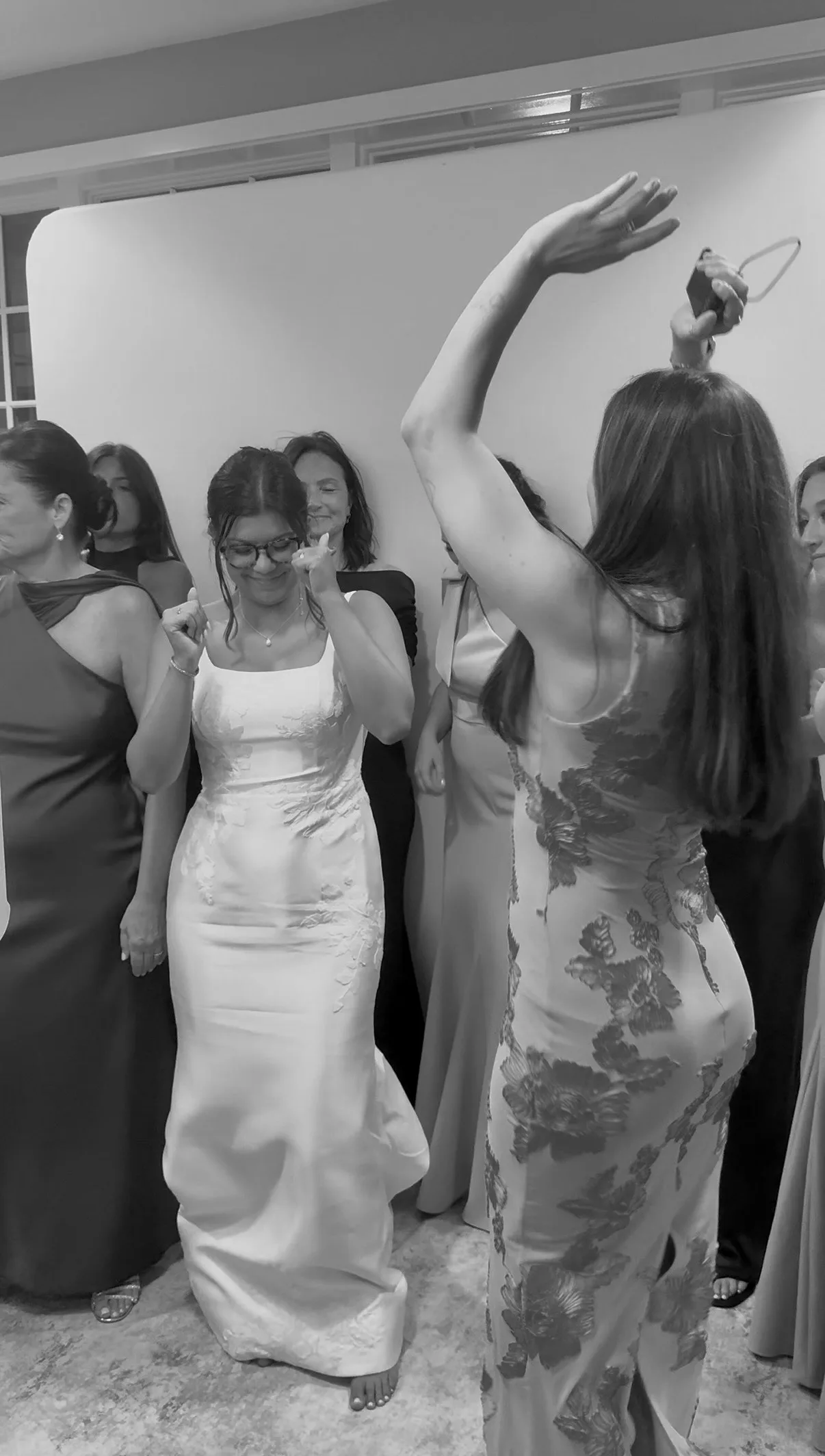 Guests celebrate beside the bride during a group portrait
