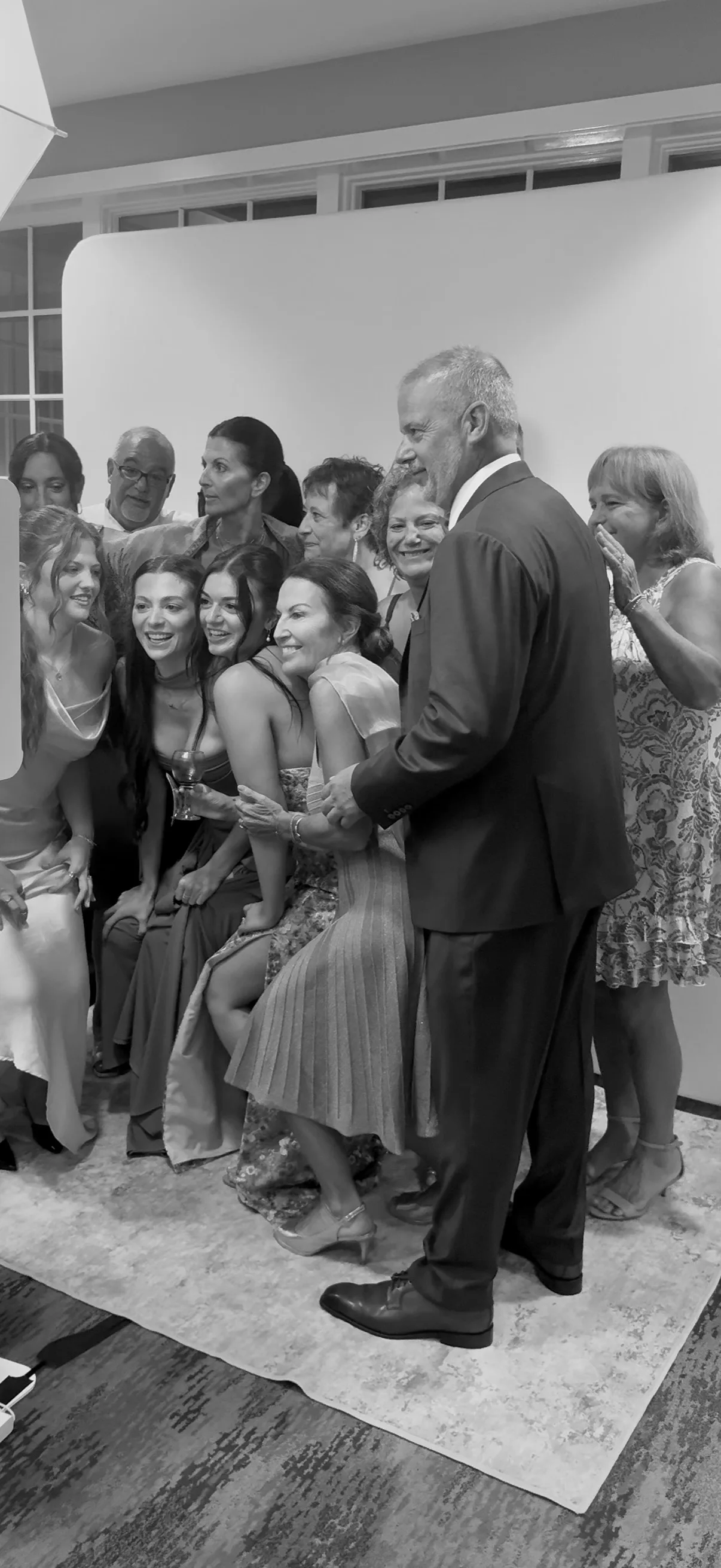 A group of guests laugh together beside the Glam Booth