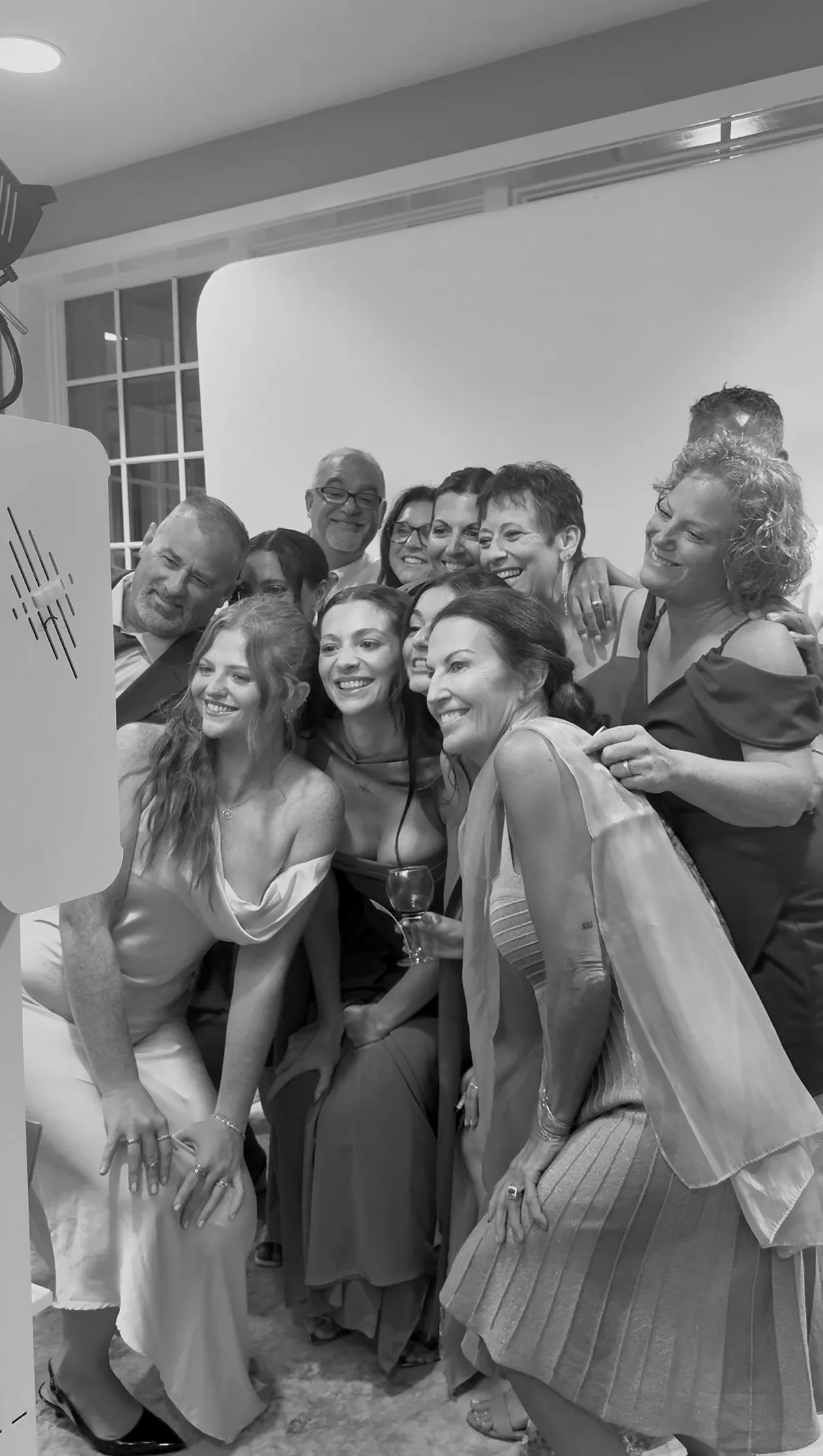 Wedding guests gather close for a group portrait