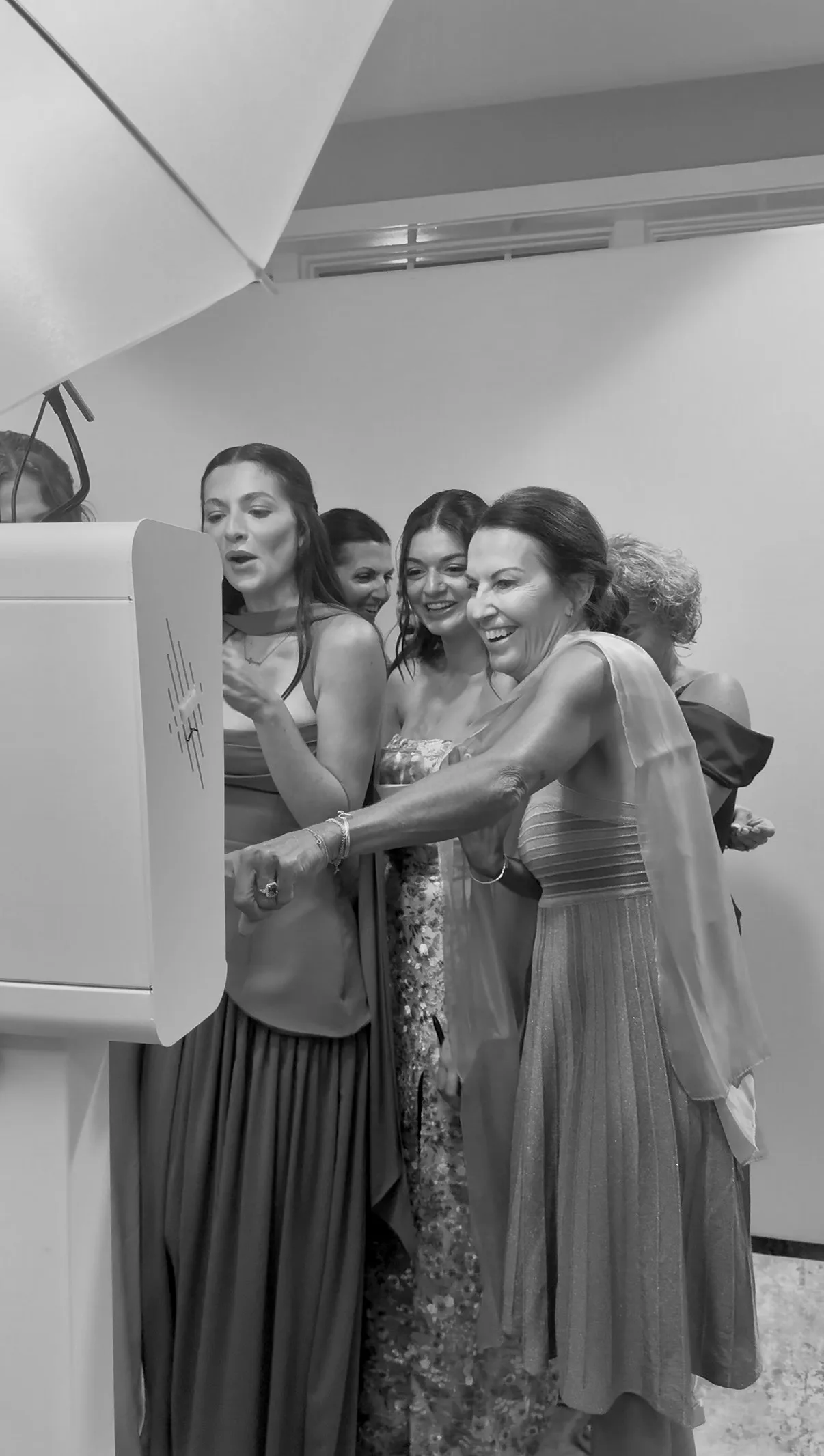 Guests laugh while using the Glam Booth