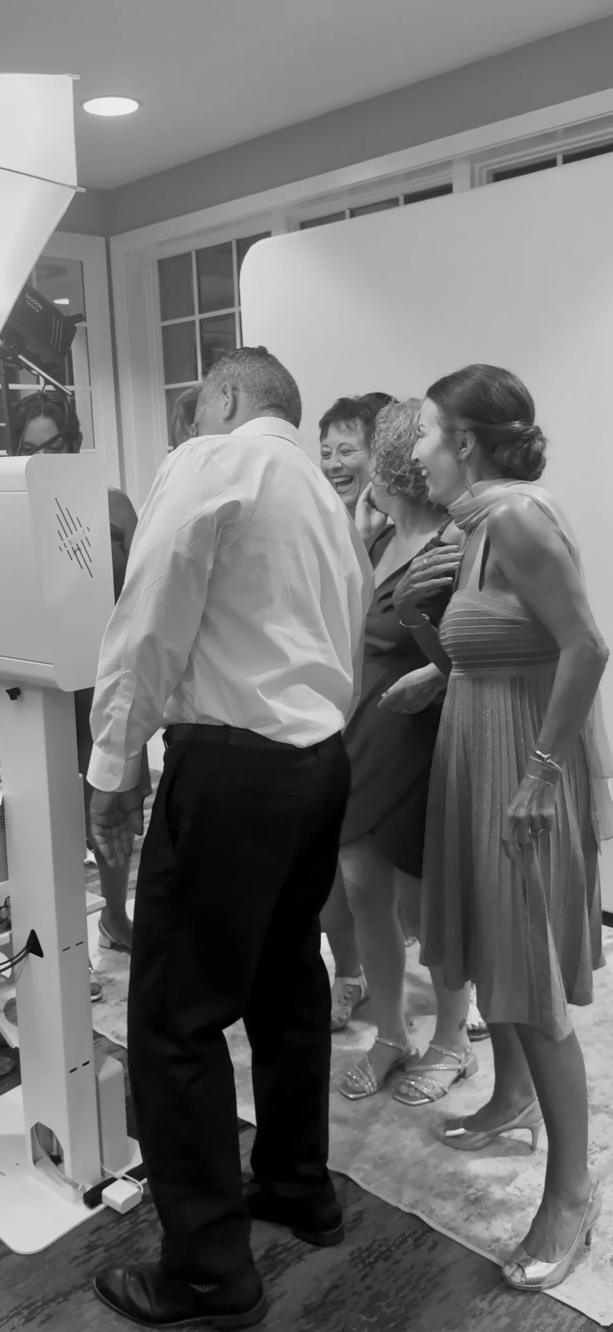 Guests stand beside the booth between portraits
