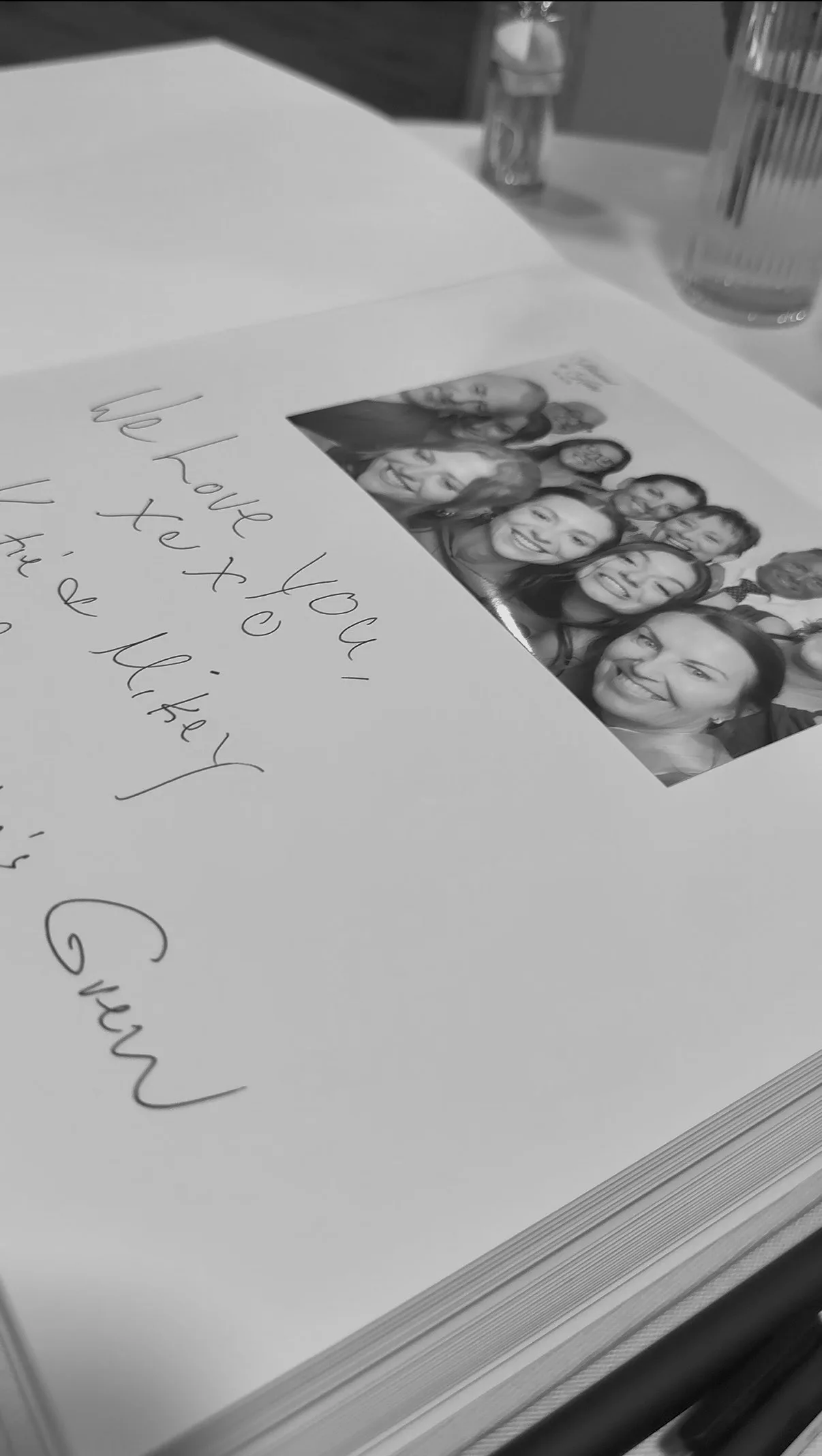 A guestbook page with wedding photos from the booth