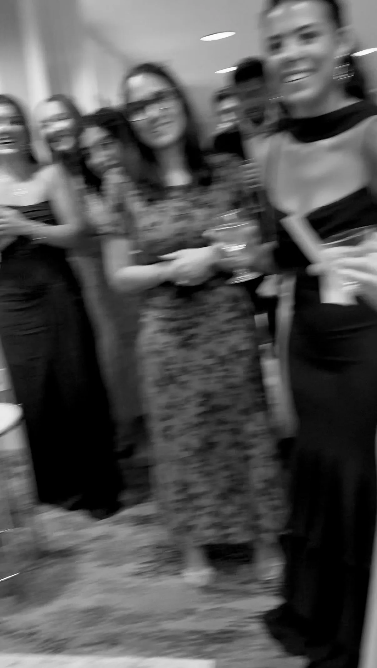 Wedding guests laugh together between photo booth sessions