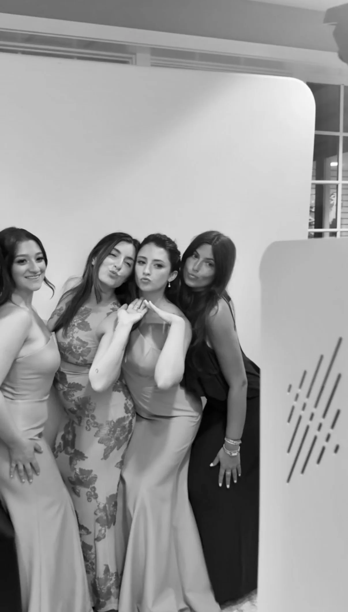 Four guests gather for another black-and-white portrait